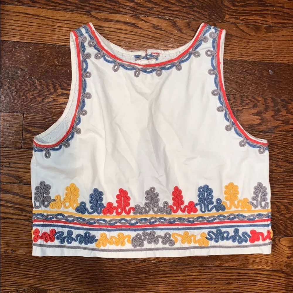 White canvas crop top with colorful accents.